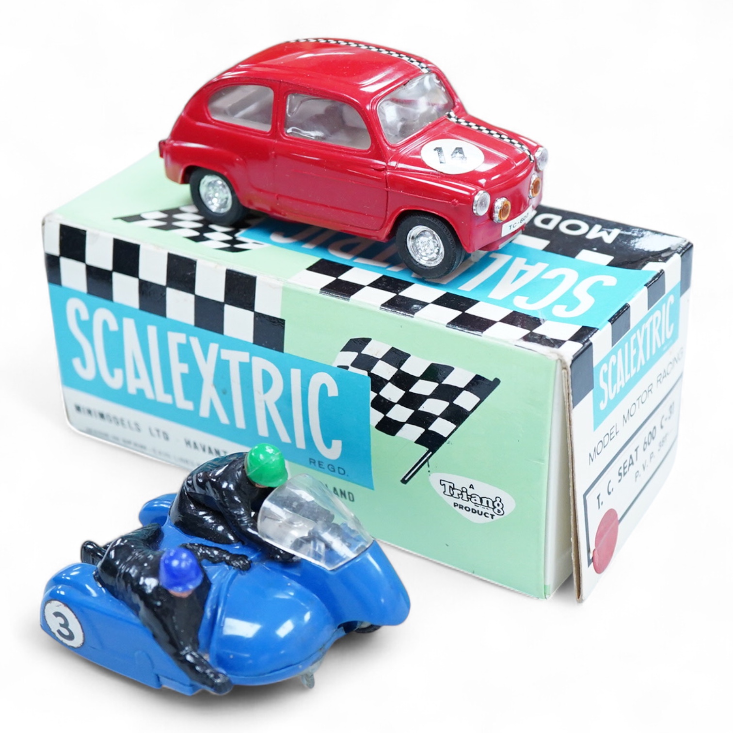 A boxed Tri-ang Scalextric T. C. Seat 600 (C-31) in red, with correct red spot box, together with an unboxed Hurricane combination motorcycle and sidecar MM/82
